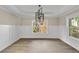 This living room features hardwood floors, white wainscoting and modern light fixture at 703 Sierra Ct, Canton, GA 30114