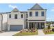 Charming two-story townhome with a painted brick facade, attached garage, and well-maintained landscaping at 982 Sutherland Ln (Lot 30), Lawrenceville, GA 30043
