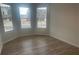 Bright bedroom features large windows with neighborhood view and light wood-look flooring at 117 Longhorn Way, Auburn, GA 30102