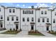 Charming townhomes with white exteriors, black accents, garages, and beautiful curb appeal at 3154 Washburn Sw St, Atlanta, GA 30354