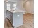 Kitchen island features modern gray cabinets and a stainless steel sink at 3154 Washburn Sw St, Atlanta, GA 30354