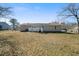 Home's back exterior showcasing the yard, a small deck, and neutral siding at 3185 Delhi Dr, Powder Springs, GA 30127