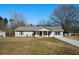 Charming one-story home featuring a well-maintained lawn and long driveway at 3185 Delhi Dr, Powder Springs, GA 30127