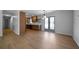 Spacious living area featuring an open layout to a kitchen with stainless appliances and wood flooring at 3185 Delhi Dr, Powder Springs, GA 30127