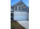 Charming two-story home with a spacious two-car garage and manicured landscaping at 7018 Old Bridge Ln, Conyers, GA 30013