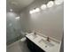 Modern bathroom featuring a double vanity with white countertops and a glass-enclosed shower with pebble flooring at 962 Bibbs Circle # 5, Atlanta, GA 30318