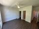 Neutral-toned bedroom with ceiling fan, large window, hardwood floors and attached bathroom at 962 Bibbs Circle # 5, Atlanta, GA 30318