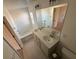 Bright bathroom featuring double sinks, a soaking tub, neutral tile flooring, and window at 2256 Triple Crown Ln, Lithonia, GA 30058