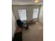 Upstairs bonus room with natural light and comfortable seating area by the window at 2256 Triple Crown Ln, Lithonia, GA 30058