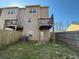 Back exterior view features balconies and a fenced backyard at 2256 Triple Crown Ln, Lithonia, GA 30058