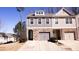 Attractive townhome featuring a stone-accented facade, gray siding, and convenient two-car garage at 2256 Triple Crown Ln, Lithonia, GA 30058