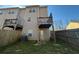 Back exterior view with multi-level balconies and fenced-in backyard at 2256 Triple Crown Ln, Lithonia, GA 30058