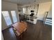 Open kitchen and dining area with stainless steel appliances, granite countertops, and hardwood floors at 2256 Triple Crown Ln, Lithonia, GA 30058