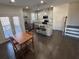 Stylish eat-in kitchen features stainless appliances, granite counters, an island, and dark hardwood floors at 2256 Triple Crown Ln, Lithonia, GA 30058