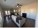 Inviting living room with a fireplace, ceiling fan, and hardwood floors leading to an eat-in kitchen at 2256 Triple Crown Ln, Lithonia, GA 30058