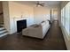 Cozy living room featuring a fireplace and hardwood floors extending into an arched hallway at 2256 Triple Crown Ln, Lithonia, GA 30058