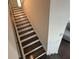 Hardwood staircase with white risers and white walls at 2256 Triple Crown Ln, Lithonia, GA 30058