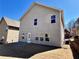 Backyard with grass, stone patio and neutral colored siding at 2359 Brynfield Cv, Suwanee, GA 30024