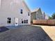 Backyard with grass, concrete patio and neutral colored siding at 2359 Brynfield Cv, Suwanee, GA 30024