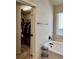 Bathroom featuring a soaking tub, window, and a walk-in closet with visible clothing storage at 2359 Brynfield Cv, Suwanee, GA 30024