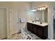 Bathroom featuring a double sink vanity with a large mirror and modern lighting at 2359 Brynfield Cv, Suwanee, GA 30024