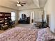 Bedroom with a vaulted ceiling, ceiling fan, and lots of natural light, featuring a large bed at 2359 Brynfield Cv, Suwanee, GA 30024
