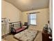 Bedroom with neutral colored walls, plush carpeting, and black metal futon at 2359 Brynfield Cv, Suwanee, GA 30024