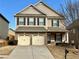 Charming two-story home with a well-maintained front yard and two-car garage at 2359 Brynfield Cv, Suwanee, GA 30024