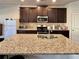 Spacious kitchen with a large island, granite countertops, and stainless steel appliances at 2359 Brynfield Cv, Suwanee, GA 30024