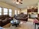 Spacious living room with a combination of carpet and hardwood flooring, and a leather seating arrangement at 2359 Brynfield Cv, Suwanee, GA 30024