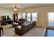 Cozy living room featuring plush leather seating and large windows for ample natural light at 2359 Brynfield Cv, Suwanee, GA 30024
