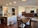Open-concept living room with hardwood floors, granite countertops, and stainless steel appliances at 2359 Brynfield Cv, Suwanee, GA 30024