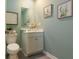 Charming powder room featuring a modern vanity, decorative mirror, and light green walls at 2402 Bayberry St, Acworth, GA 30101
