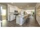 Modern, open-concept kitchen with white cabinets, a large island with seating, and stainless steel appliances at 2402 Bayberry St, Acworth, GA 30101