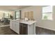 Kitchen island featuring a stainless steel dishwasher, white cabinets and drawers and quartz countertop at 2402 Bayberry St, Acworth, GA 30101