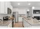 Bright, modern kitchen with stainless steel appliances and an adjacent living area at 7015 Old Bridge Ln, Conyers, GA 30013