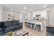 Open-concept living space with a kitchen island, dining area, and comfortable seating at 7015 Old Bridge Ln, Conyers, GA 30013