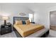 Spacious main bedroom with a decorative headboard, two side tables, and a window at 7015 Old Bridge Ln, Conyers, GA 30013