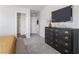 View of Primary bedroom with a decorative dresser and a big tv mounted on the wall at 7015 Old Bridge Ln, Conyers, GA 30013