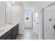 Bright bathroom features double vanity, framed mirror, and glass-enclosed shower at 204 Groveton Ct, Euharlee, GA 30145