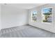 Bright bedroom with carpet and two windows offering natural light at 204 Groveton Ct, Euharlee, GA 30145