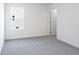 Spacious bedroom with plush carpet, a window, and a door to another room at 204 Groveton Ct, Euharlee, GA 30145