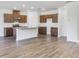 Open-concept kitchen features an island, stainless steel appliances, and brown cabinetry at 204 Groveton Ct, Euharlee, GA 30145