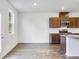 Open-concept kitchen featuring granite countertops, stainless steel appliances, and wood look floors at 204 Groveton Ct, Euharlee, GA 30145
