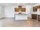 Open-concept kitchen with granite countertops, stainless steel appliances, wood look floors, and lots of light at 204 Groveton Ct, Euharlee, GA 30145