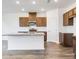 Bright kitchen featuring granite countertops, stainless steel appliances, and dark wood cabinets at 204 Groveton Ct, Euharlee, GA 30145