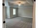 Large bedroom with a tray ceiling, a ceiling fan, neutral walls, and carpeting at 4015 Sierra Vista Cir, Cumming, GA 30028