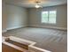 Bonus room features neutral carpeting, a ceiling fan, and a large window at 4015 Sierra Vista Cir, Cumming, GA 30028