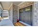 Stylish home entrance with a modern, gray double door, brick facade, and a 'Welcome' mat at 4015 Sierra Vista Cir, Cumming, GA 30028