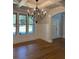 Bright living room with coffered ceiling, large windows, chandelier, and wainscoting at 4015 Sierra Vista Cir, Cumming, GA 30028